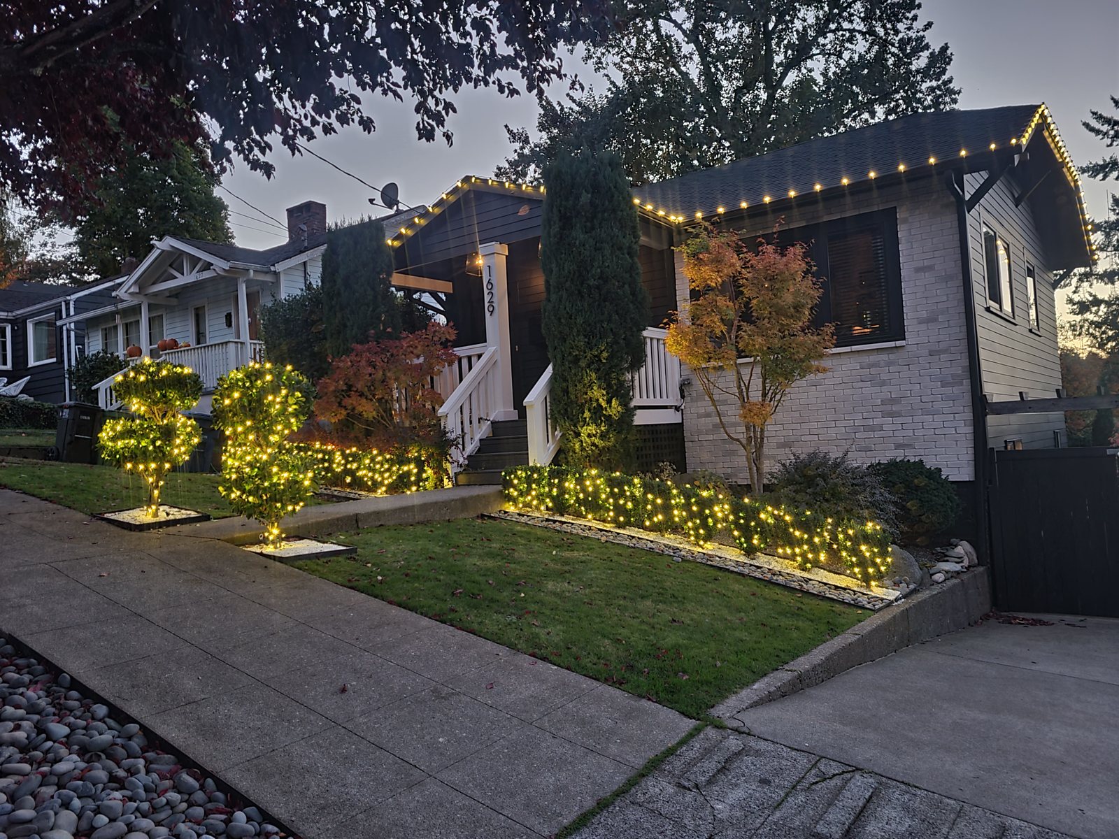 Single-story home with warm white roofline and landscape lighting