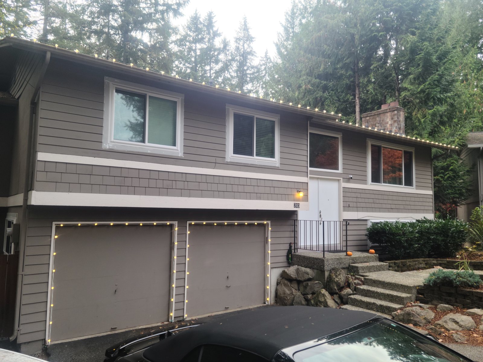 Two-story home with roofline lighting installed along the gutter line