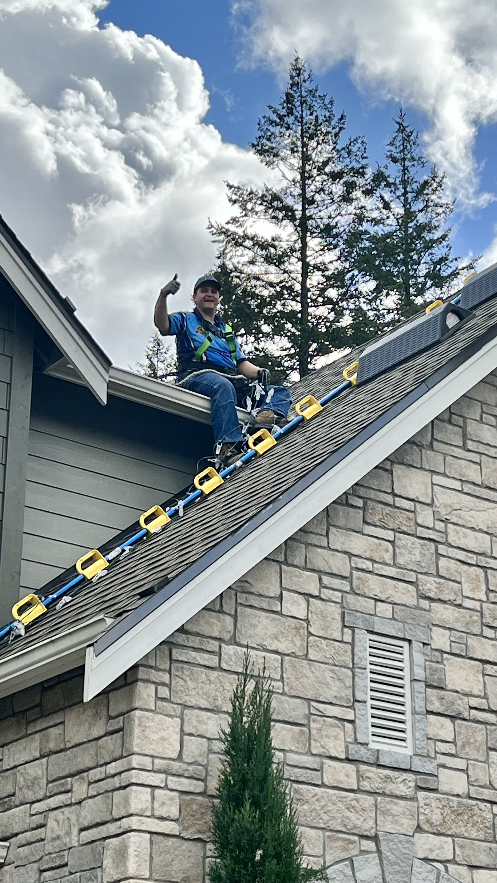 Installer on a ladder at a roofline in winter — Seattle, WA