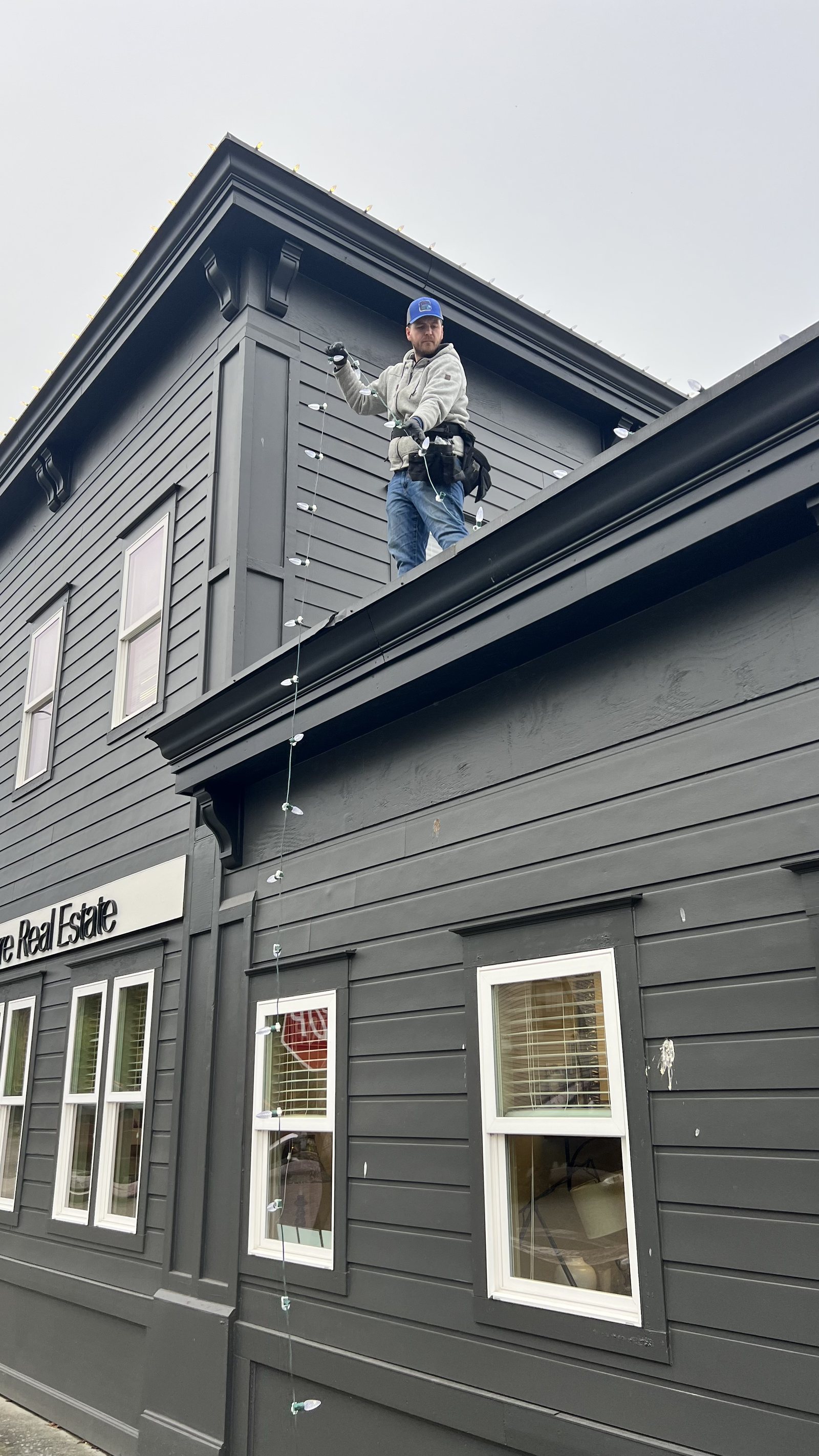 Installer working on the upper storey of a commercial building