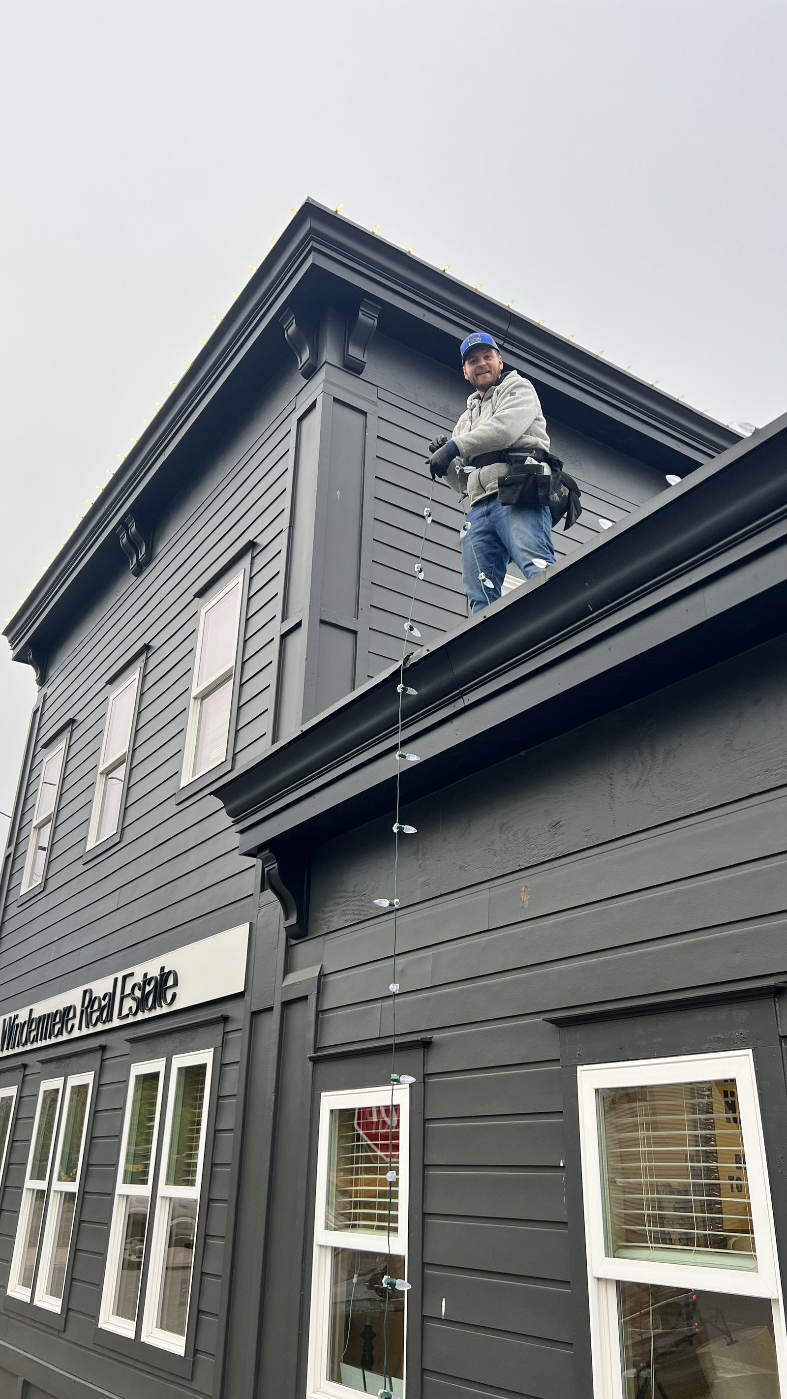 Crew installing lighting along a commercial building roofline — Redmond, WA